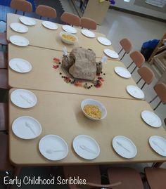 the table is set with many plates and bowls