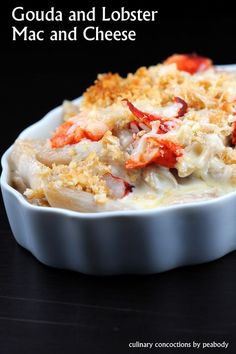 a close up of a plate of food on a table with the words goula and lobster mac and cheese