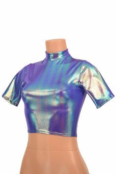 "This item is made to order, please read all the way through the listing before purchasing! This shiny, liquidy holographic top has a smooth reflective finish that bends the light in beautiful shifting rainbows. It features a high short collar neckline and cute little tee length sleeves. Four way stretch spandex for a great fit! TOP LENGTH: Underarm to hemline measures 8\" Womens Sizing (See below for instructions on where measurements should be taken) XXS: Bust 29\"-30\" / Waist 22\"-23\" / Hip Trendy Fitted Shiny Tops, Metallic Shiny Fitted Crop Top, Fitted Metallic Shiny Crop Top, Fitted Iridescent Tops, Metallic Shiny Fitted Tops, Fitted Metallic Shiny Tops, Metallic Shiny Disco Top, Metallic Shimmer Top For Disco, Metallic Shimmer Disco Top