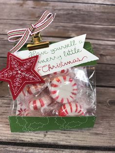 christmas candies in a gift bag with a holiday sign on it's side