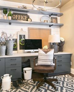 a home office with gray cabinets and white walls