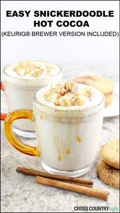 two mugs filled with hot cocoa on top of a table