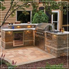 an outdoor kitchen is built into the side of a house