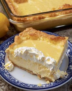 a slice of lemon pie on a plate next to a baking pan with the rest of the pie in it