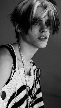 black and white photograph of a young man with short hair wearing a tank top shirt