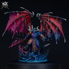 a figurine is displayed on top of a stand with chains around it's wings