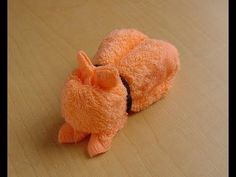 an orange stuffed animal laying on top of a wooden floor