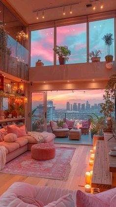 a living room filled with lots of furniture next to tall windows and candles on the floor