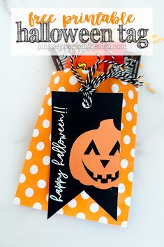 an orange and black halloween tag with a jack - o'- lantern on it