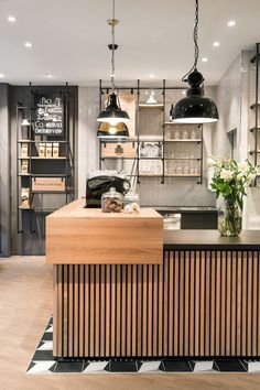 a kitchen with wooden counter tops and hanging lights