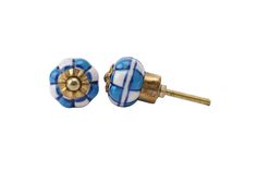 a pair of blue and white ceramic knobs with gold accents on each one side