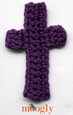 a crocheted purple cross on a white background