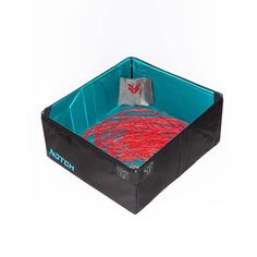 a black and blue dog bed with red designs on the bottom, in front of a white background