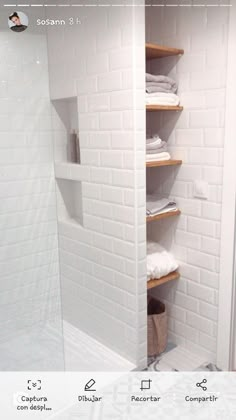 a white tiled shower with shelves in it