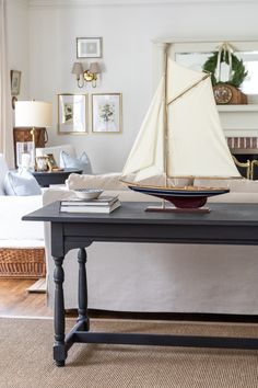 a table with a sailboat on it in a living room