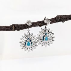 These beautiful earrings feature a pair of 13.98 carat weight pear shape Blue Zircon gemstones with natural earth mined diamonds set in solid 14K gold. These earrings make a lovely December birthstone gift for your loved ones! These earrings are made with solid 14k Gold and natural earth mined SI / G-H Diamonds. As listed, these earrings are ready to ship. If you're interested in purchasing this setting with a different center stone please message us! Blue Drop Earrings With Natural Stones, Blue Birthstone Dangle Earrings, Blue Cubic Zirconia Birthstone Earrings, Blue Cubic Zirconia Gemstone Earrings, Designer Silver Jewellery, Blue Multi-stone Cubic Zirconia Earrings, Jewelry Showcases, Birthstone Gifts, December Birthstone