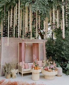 an outdoor seating area with pink and white decor