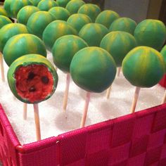 green and red lollipops in a pink basket