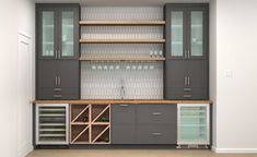 a kitchen with gray cabinets and wine glasses on the top shelf in front of it