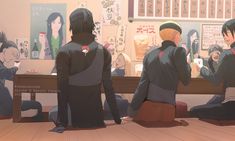 three people sitting on the floor in front of a table with anime characters behind them