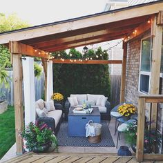 a covered patio with furniture and string lights