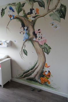 a child's room painted with cartoon characters on the wall and in the tree