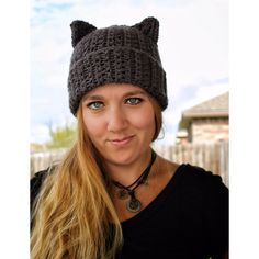 a woman wearing a knitted cat hat