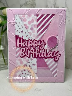 a pink birthday card with white flowers in the background