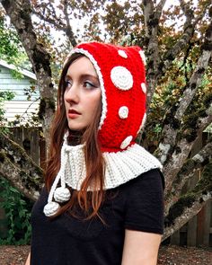 a woman wearing a red and white crocheted hat