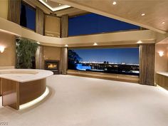 a large bathroom with an oval tub in front of a huge window overlooking the city