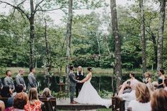 a bride and groom are getting married in the woods