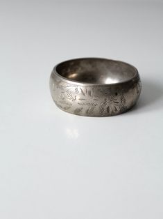 "This is a vintage etched bangle bracelet. The wide chunky bangle is silver tone and has an etched design picturing an elephant jungle scene. CONDITION In good condition with wear consistent with age and use. MEASUREMENTS Exterior Circumference: 9.5\" .. 24.1 cm Interior Diameter: 2.75\" ... 7 cm Width: 1.125\" .. 2.9 cm 102014" Silver Engraved Wide Band Bangle, Elephant Jungle, Jungle Scene, Bracelet Shop, An Elephant, Vintage Clothing Online, Small Light, Picture Design, Bangle Bracelet