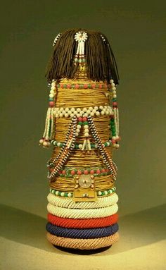 a stack of bracelets sitting on top of a table next to a lamp shade