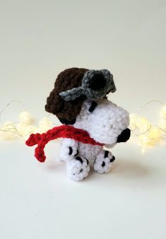 there is a crocheted dog with a hat and scarf on it's head