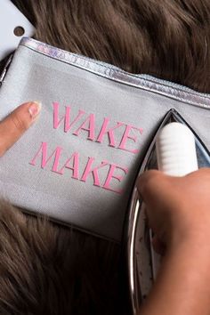 someone is using a hair dryer to make their own name on a fabric bag