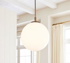 a white light hanging from a ceiling in a living room