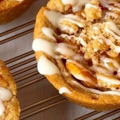 several desserts sitting on top of a cooling rack with icing and toppings