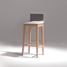 a wooden stool with grey upholstered seat and backrests in front of a white background