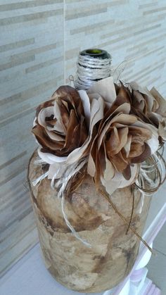 a vase with flowers in it sitting on a shelf