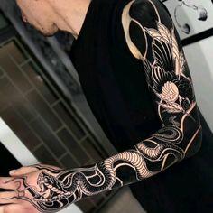 a man with a dragon tattoo on his arm