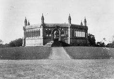 an old black and white photo of a building with stairs leading up to the top