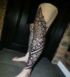 a man's leg with a flower tattoo on it and his lower half sleeve