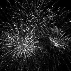 black and white fireworks in the night sky