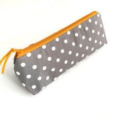 This zip pouch is perfect for storing your pens & pencils, make-up, or your everyday essentials in. It would make the perfect birthday or occasion gift or even a little treat for yourself!  Made from: - Outside - 100% Cotton fabric, Interfacing - Inside - You can choose from 2 options -  1. Mustard 100% cotton fabric OR  2. Plain white waterproof fabric (polyurethane coated nylon).  - Other - Nylon zip, faux suede pull Dimensions: (Approximate) Length: Bottom - 22cm, Zip - 21cm, Widest point - 2 Dot Makeup, Pens Pencils, Storage Pouch, Coin Purses, Purse Pouch, Zip Pouch, Plain White, Glasses Case, Perfect Birthday