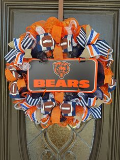 an orange and blue football wreath with the chicago bears on it's front door