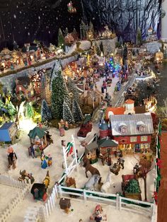 a christmas village with horses and people in it