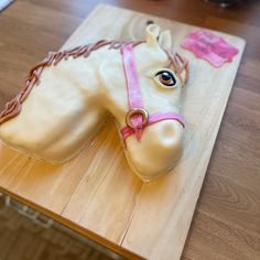 a cake shaped like a horse on top of a wooden table