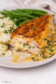 a white plate topped with meat and green beans