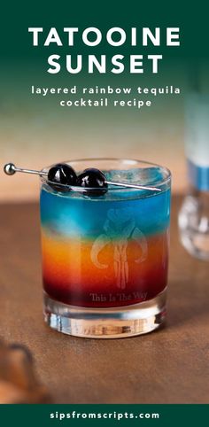 a colorful cocktail with an olive on the rim