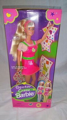 a barbie doll in a pink dress holding a crafting kit on a white background